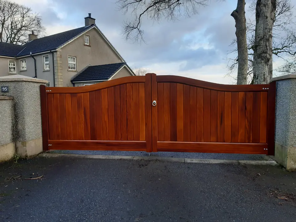 Arched Iroko hardwood driveway gates with mortice and tenon frame